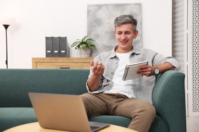 Photo of Professional psychologist working with laptop and notebook in office