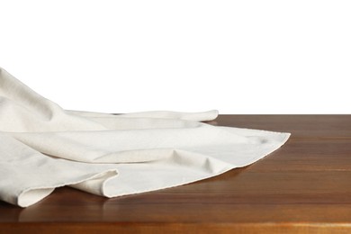 Photo of Light tablecloth on wooden table against white background, closeup