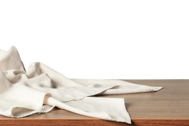 Photo of Light tablecloth on wooden table against white background, closeup