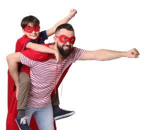 Photo of Father and his son wearing superhero costumes on white background