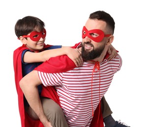 Photo of Father and his son wearing superhero costumes on white background