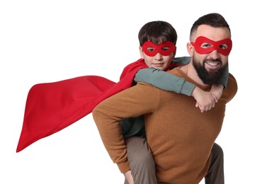 Photo of Father and his son wearing superhero costumes on white background