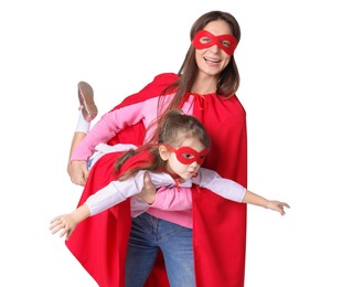 Photo of Mother and her cute little daughter wearing superhero costumes on white background