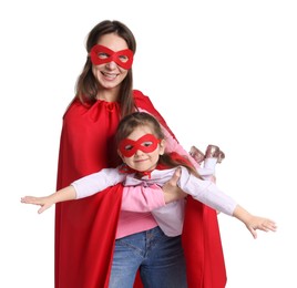 Photo of Mother and her cute little daughter wearing superhero costumes on white background