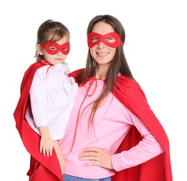 Photo of Mother and her cute little daughter wearing superhero costumes on white background