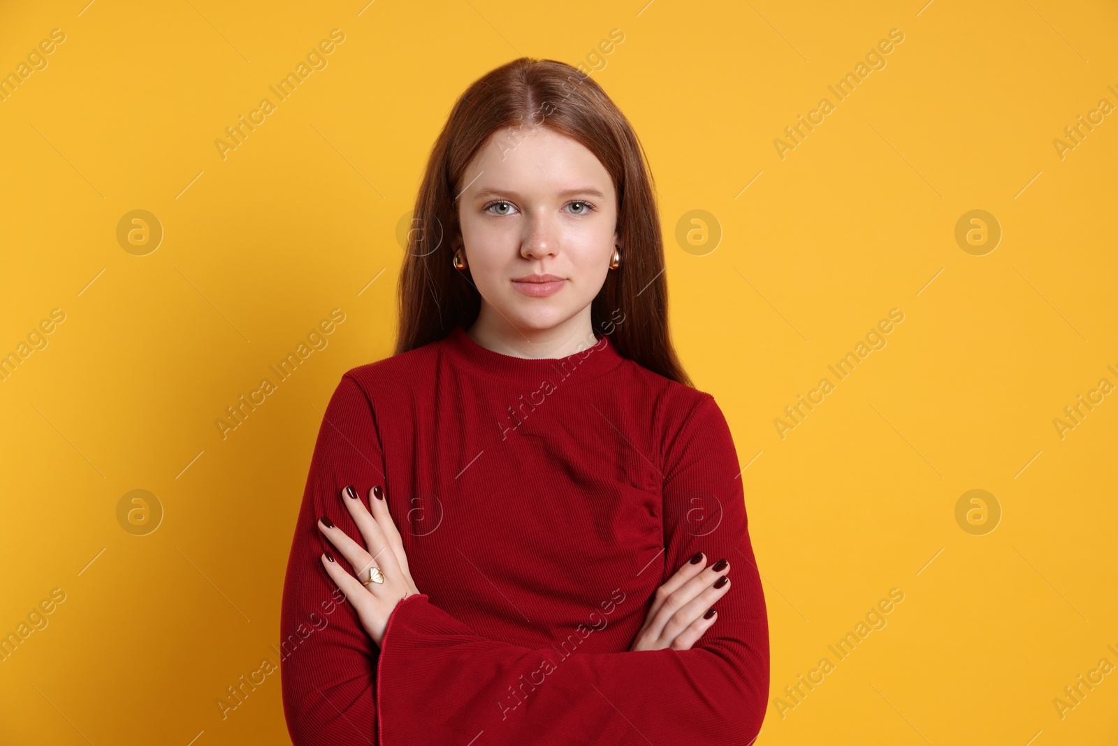 Photo of Teenage girl wearing stylish jewellery on yellow background