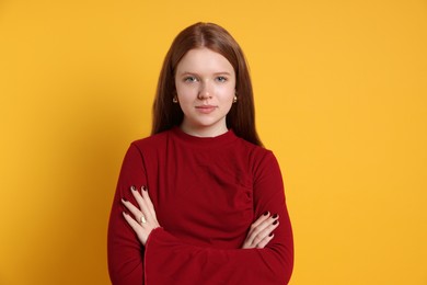 Photo of Teenage girl wearing stylish jewellery on yellow background