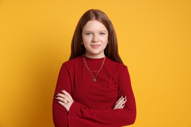 Photo of Teenage girl wearing stylish jewellery on yellow background