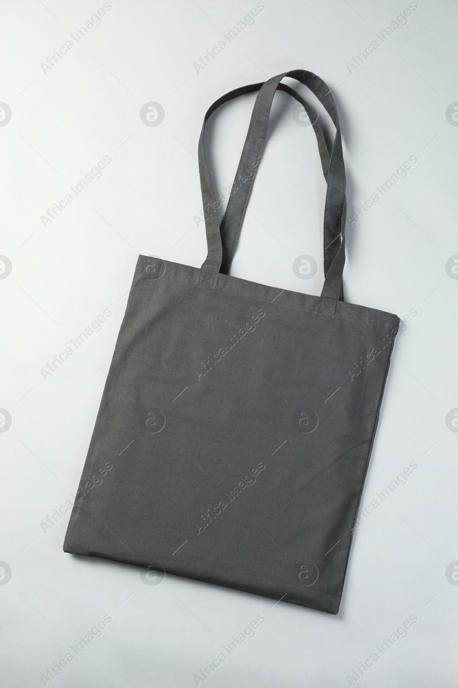 Photo of One shopping bag on grey background, top view. Mockup for design