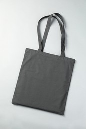 One shopping bag on grey background, top view. Mockup for design