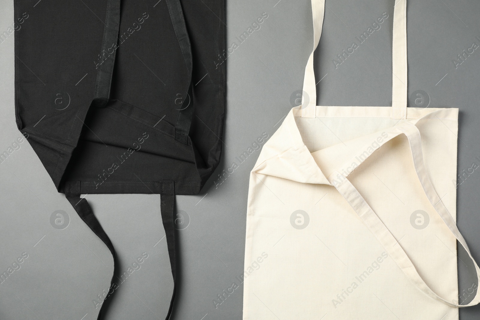 Photo of Shopping bags on grey background, flat lay. Mockup for design