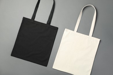 Photo of Shopping bags on grey background, flat lay. Mockup for design