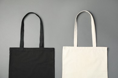 Shopping bags on grey background, flat lay. Mockup for design