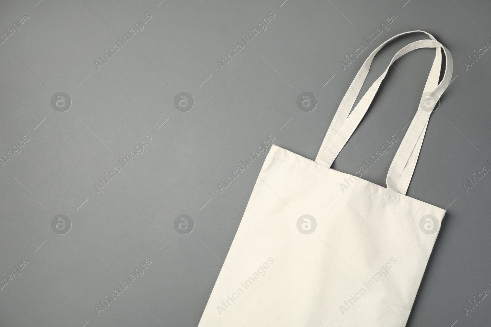 Photo of One shopping bag and space for text on grey background, top view. Mockup for design