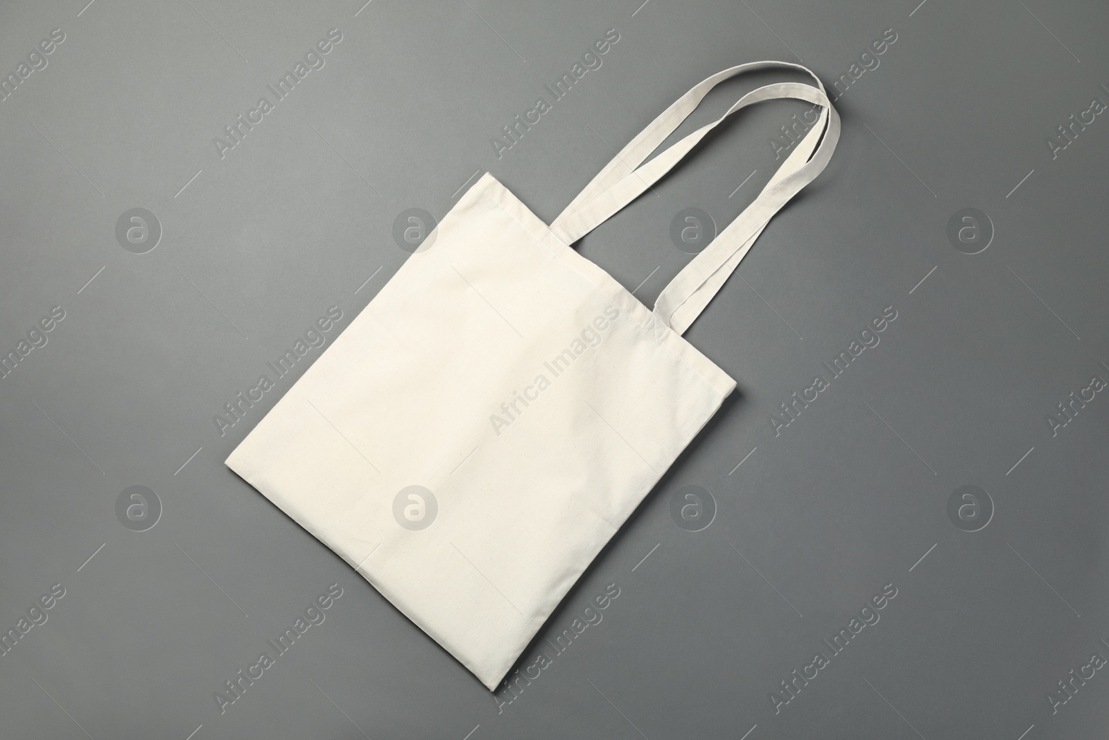 Photo of One shopping bag on grey background, top view. Mockup for design