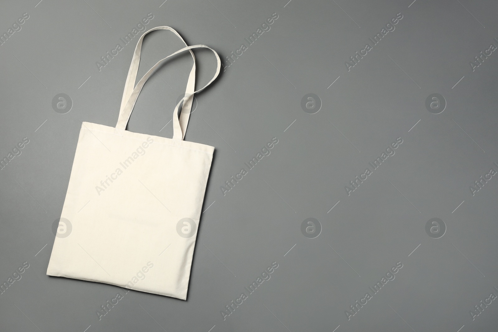 Photo of One shopping bag and space for text on grey background, top view. Mockup for design