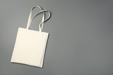 One shopping bag and space for text on grey background, top view. Mockup for design