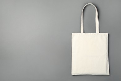 Photo of One shopping bag and space for text on grey background, top view. Mockup for design