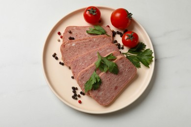 Photo of Pieces of tasty canned meat, parsley, peppercorns and tomatoes on white marble table, top view