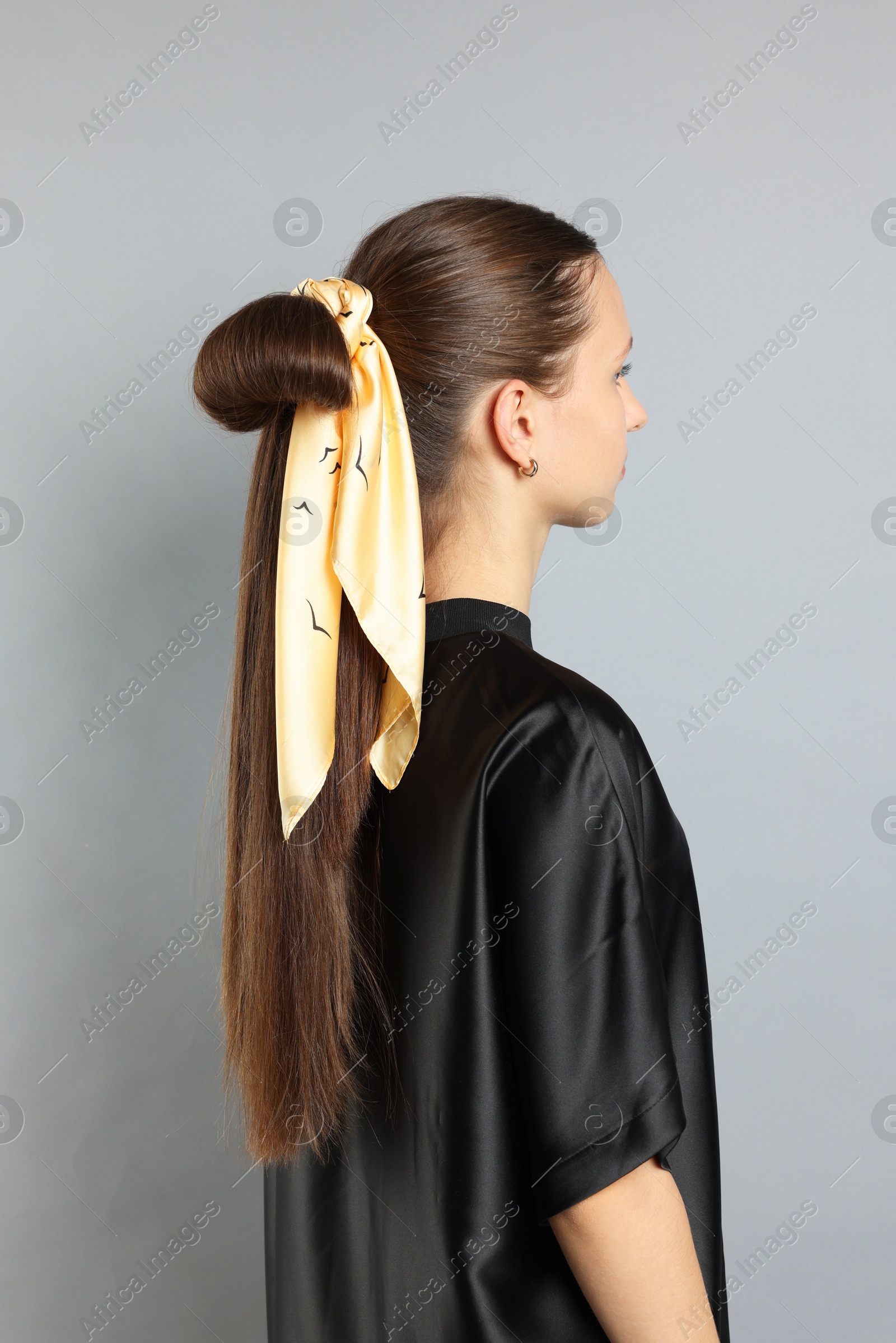 Photo of Teenage girl with stylish bandana on light grey background