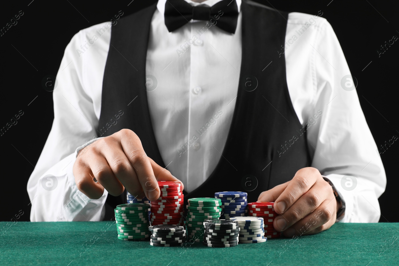 Photo of Man with casino chips playing poker at gambling table, closeup