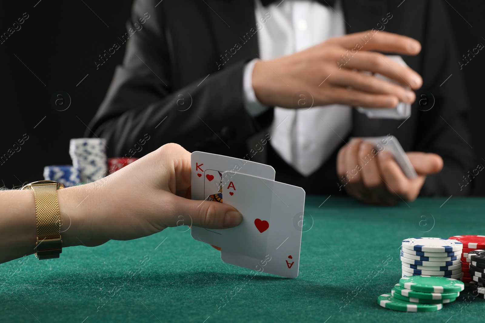 Photo of People playing poker with cards and casino chips at gambling table, closeup