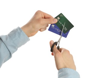 Woman cutting credit cards on white background, closeup