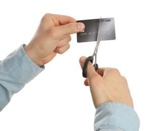 Woman cutting credit card on white background, closeup