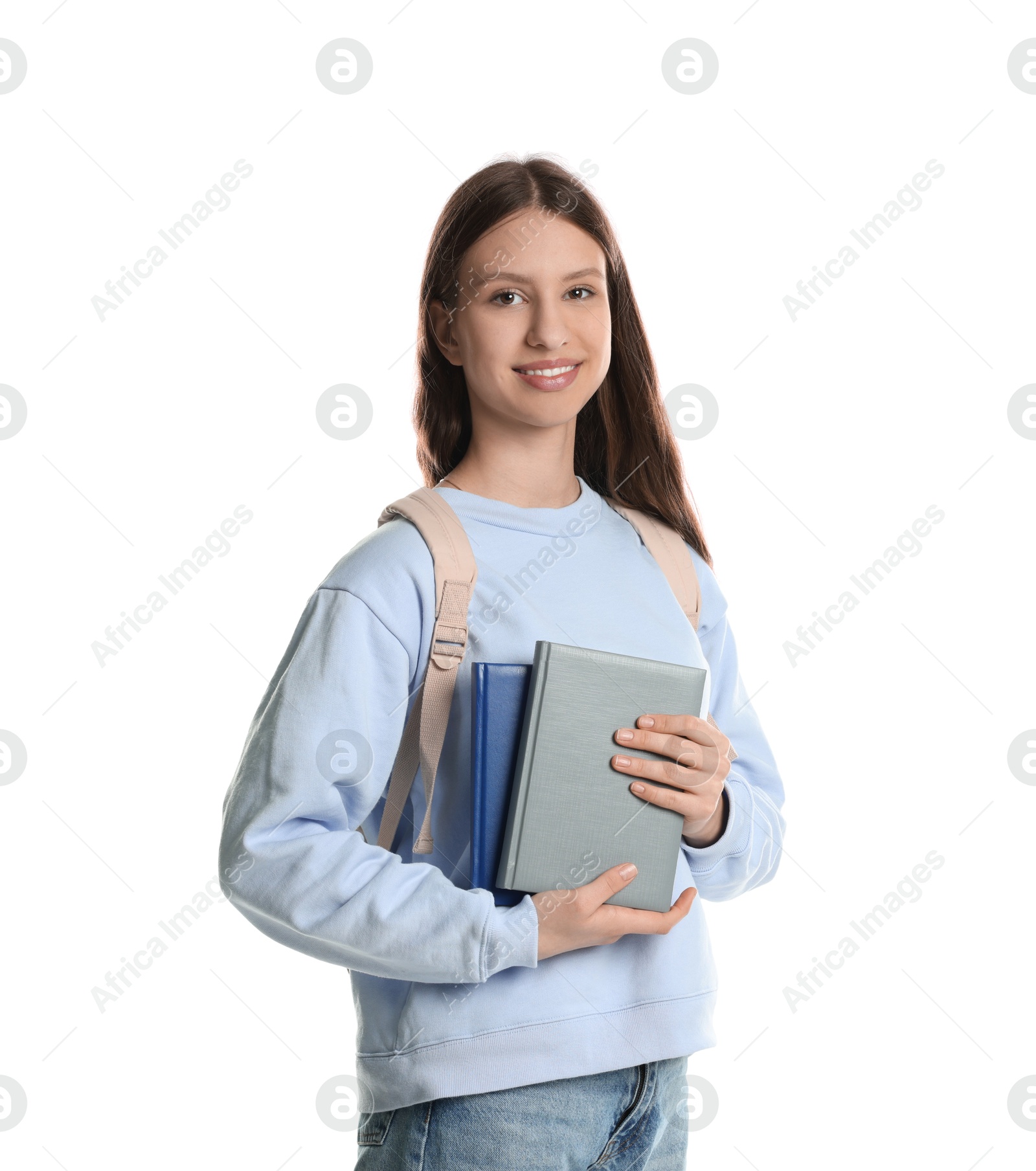 Photo of Portrait of smiling teenage girl with books on white background