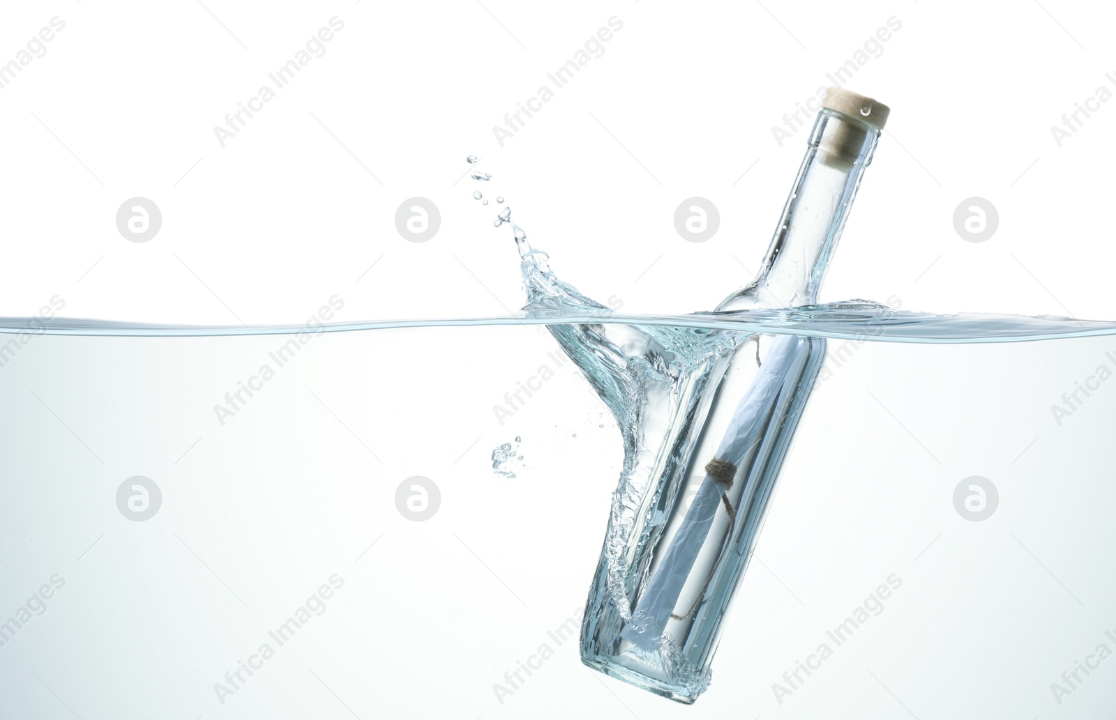 Photo of Corked glass bottle with rolled letter in water on white background