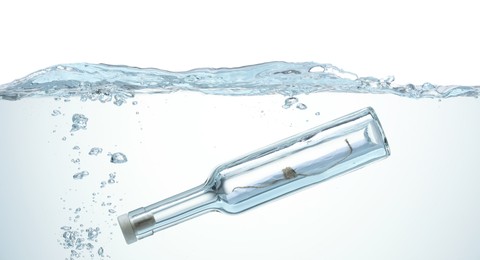 Photo of Corked glass bottle with rolled letter in water on white background