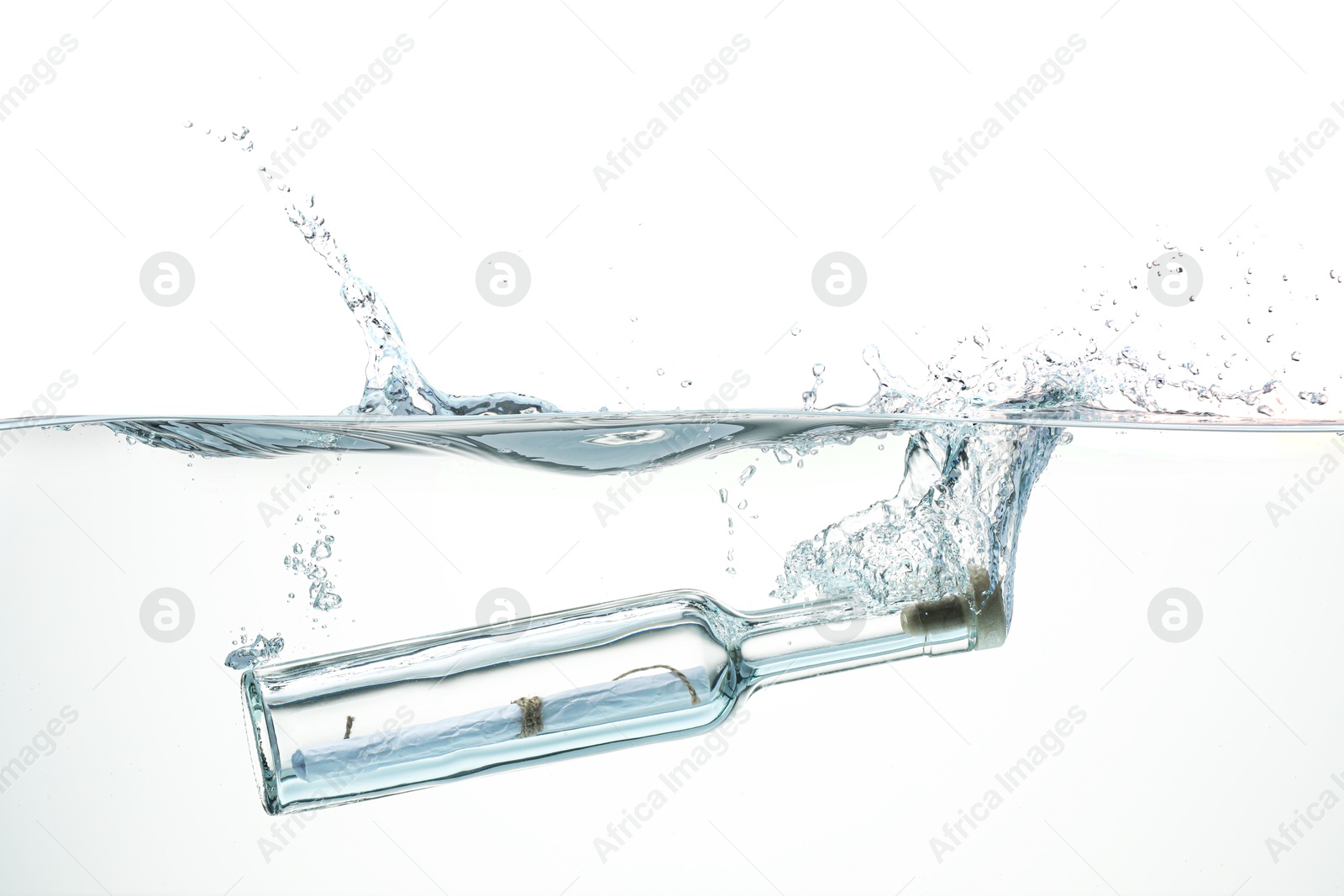 Photo of Corked glass bottle with rolled letter in water on white background