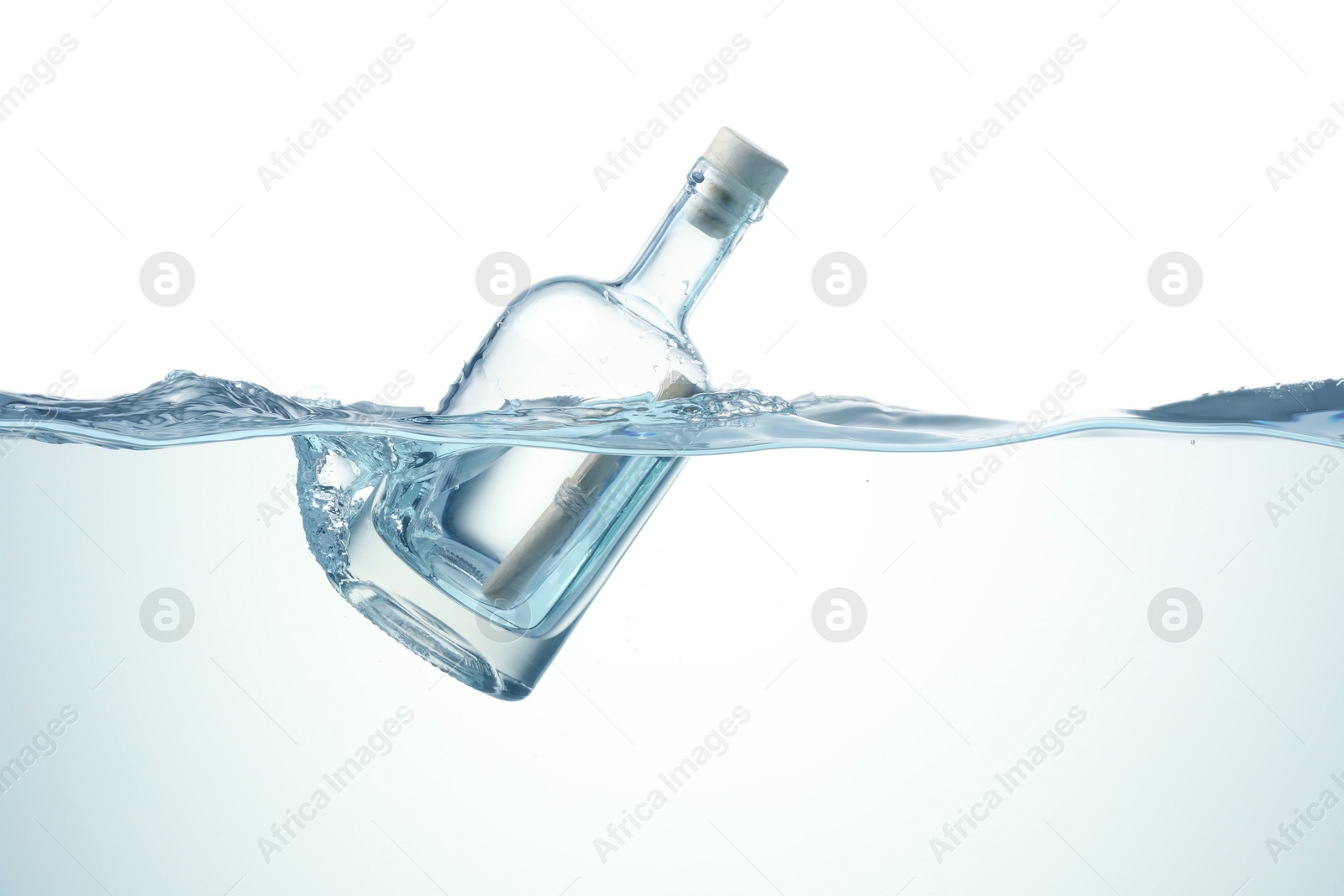 Photo of Corked glass bottle with rolled letter in water on white background