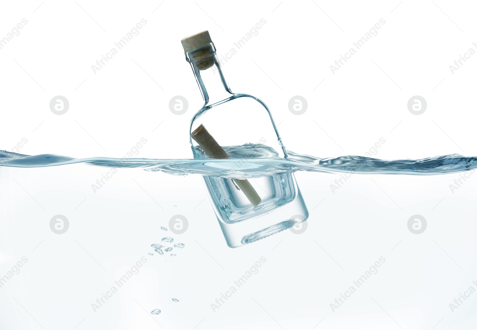 Photo of Corked glass bottle with rolled letter in water on white background