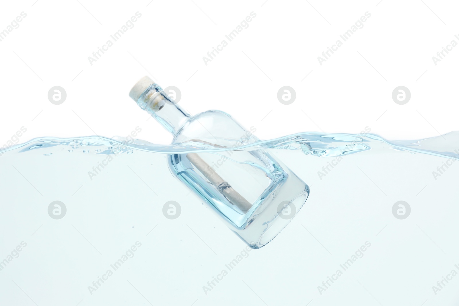 Photo of Corked glass bottle with rolled letter in water on white background