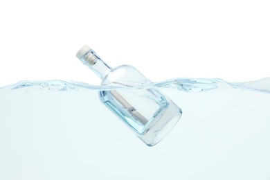 Photo of Corked glass bottle with rolled letter in water on white background