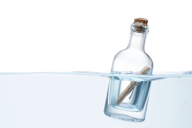 Photo of Corked glass bottle with rolled letter in water on white background