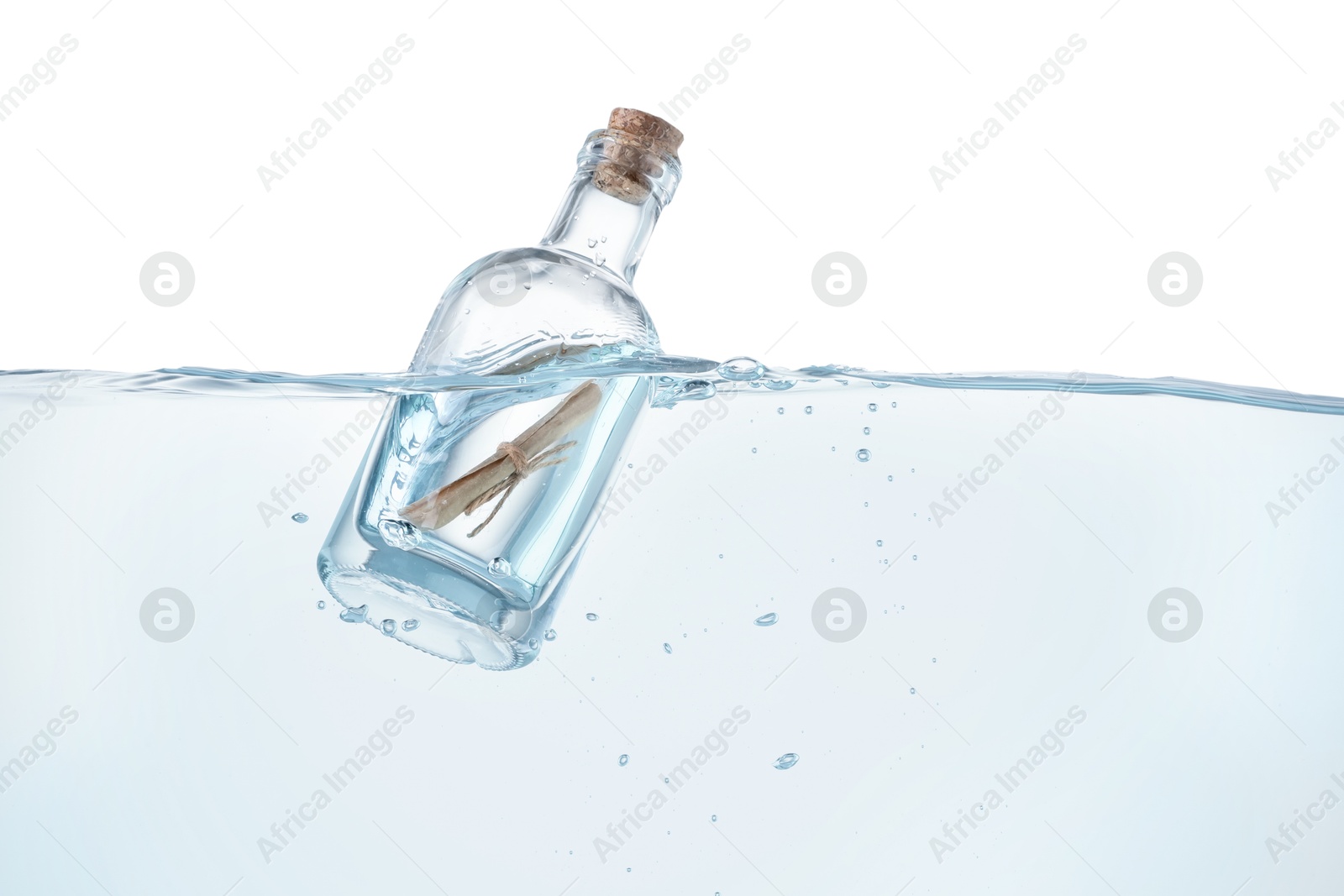 Photo of Corked glass bottle with rolled letter in water on white background