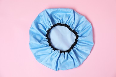 Photo of One shower cap on pink background, top view