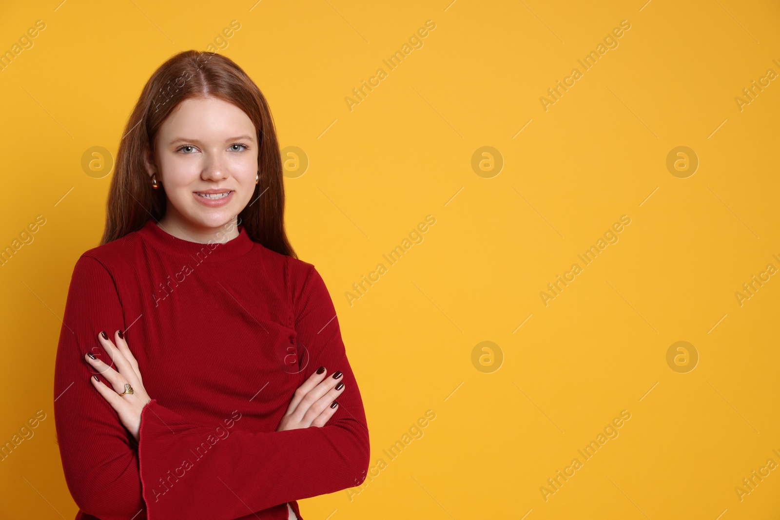 Photo of Teenage girl wearing stylish jewellery on yellow background, space for text