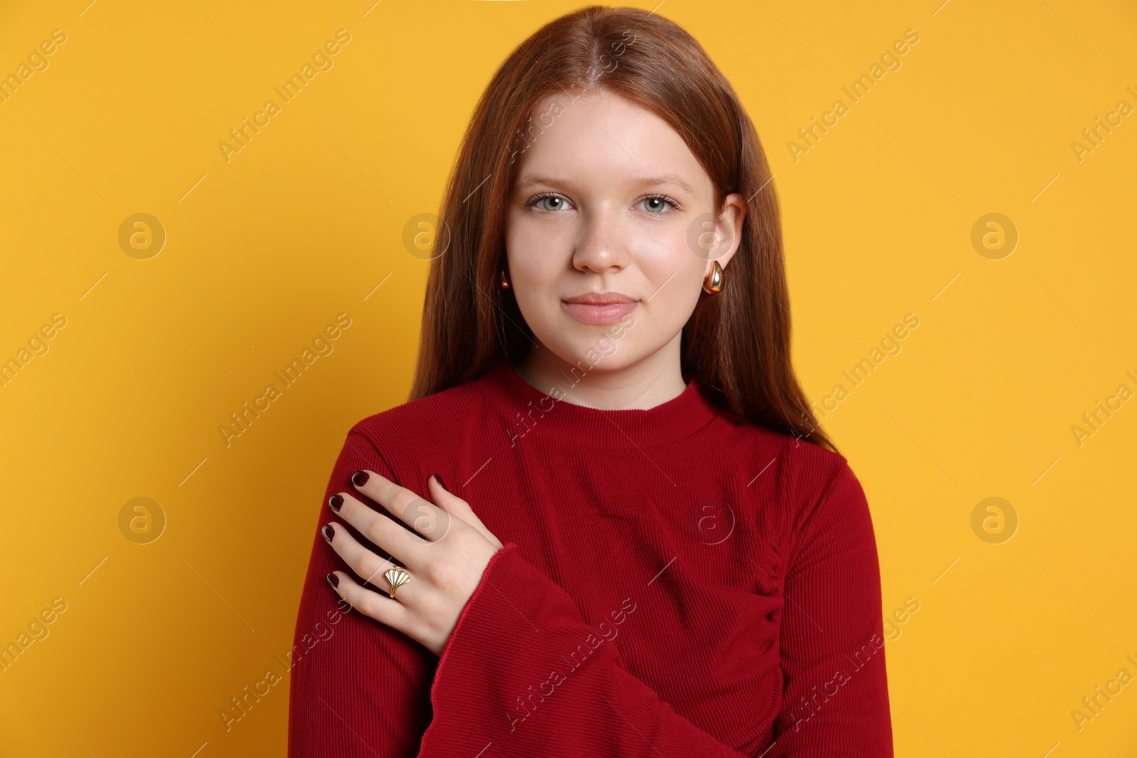 Photo of Teenage girl wearing stylish jewellery on yellow background