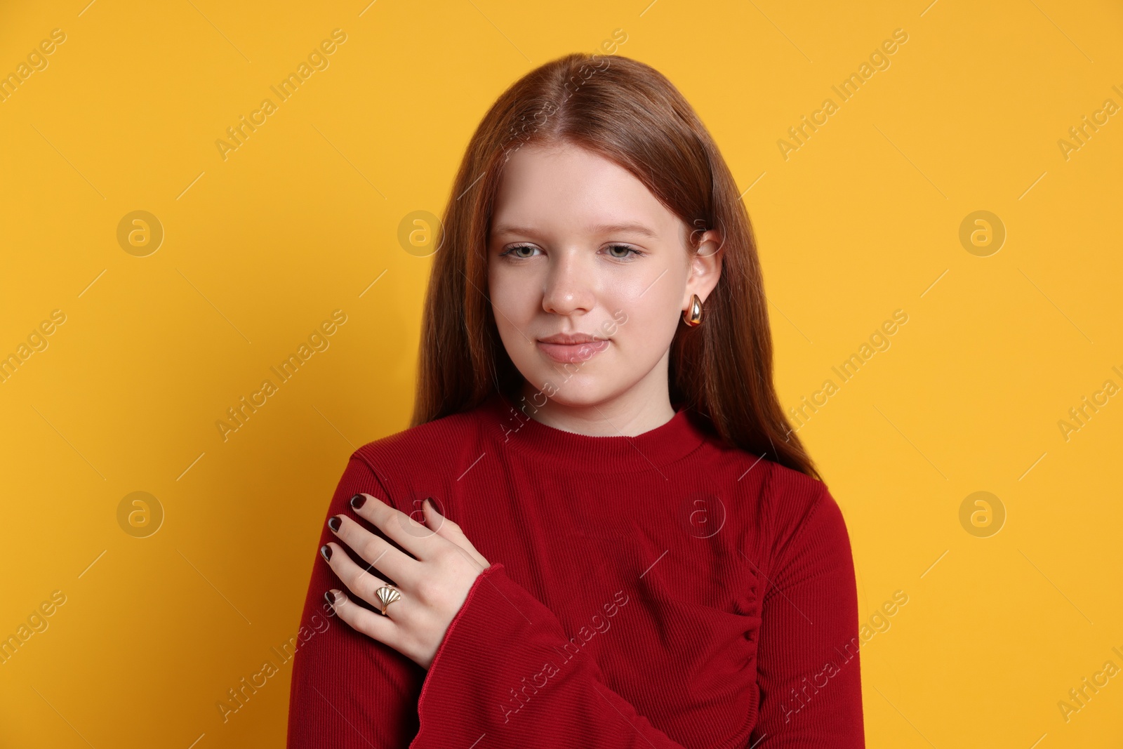 Photo of Teenage girl wearing stylish jewellery on yellow background