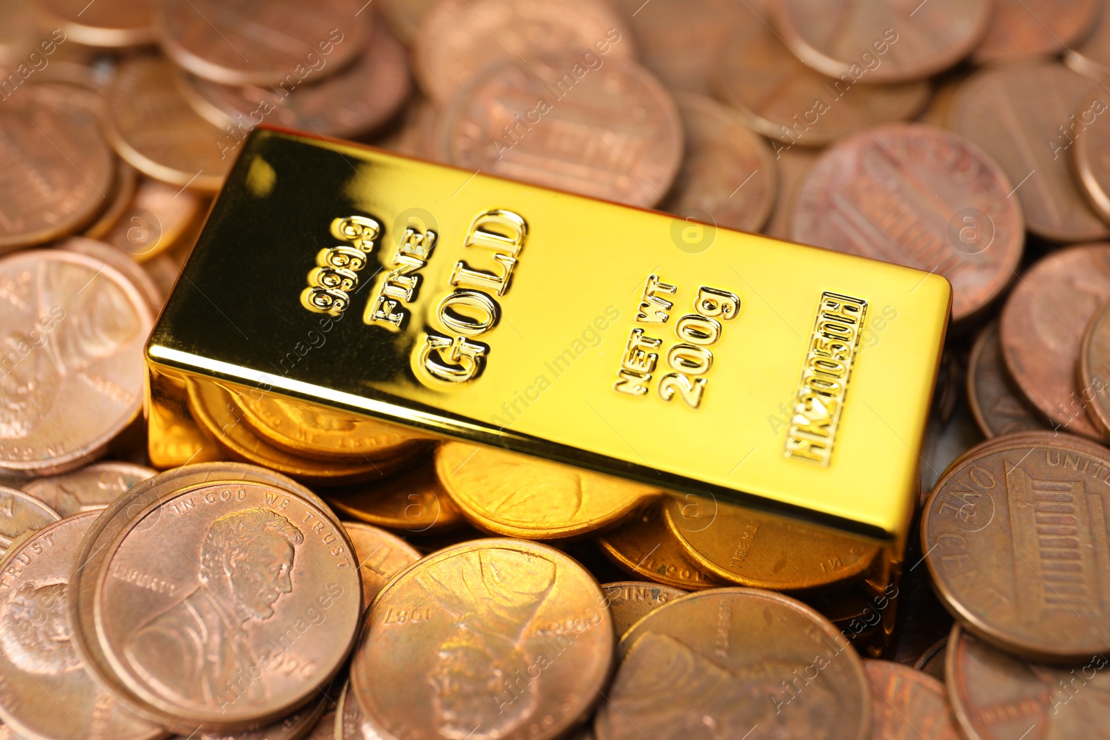 Photo of Gold bar on coins as background, closeup