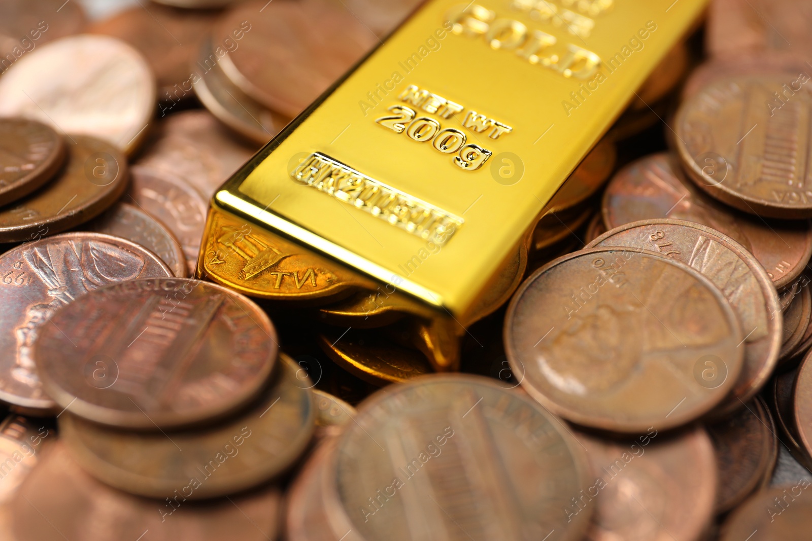 Photo of Gold bar on coins as background, closeup