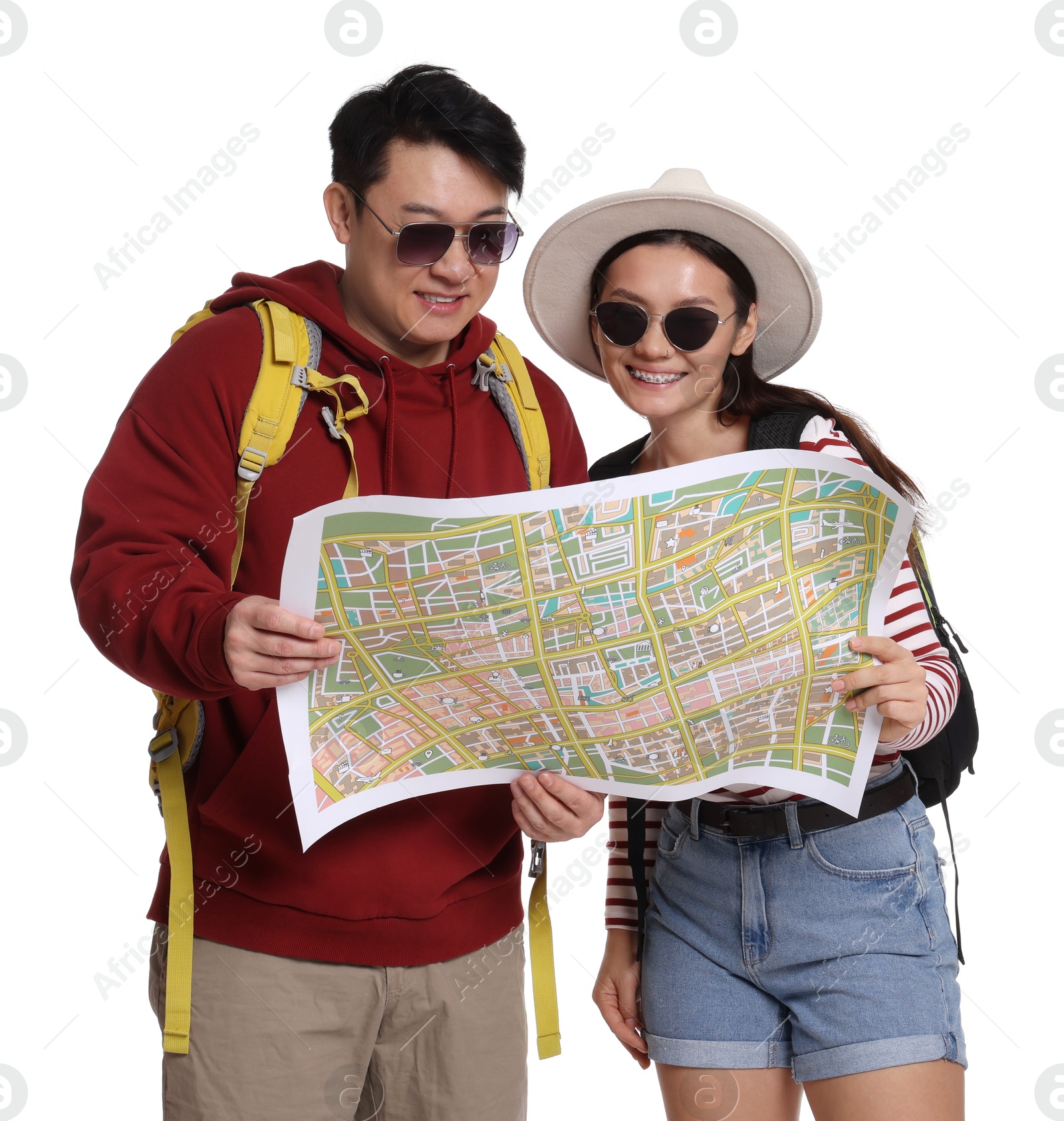 Photo of Happy travellers with map on white background