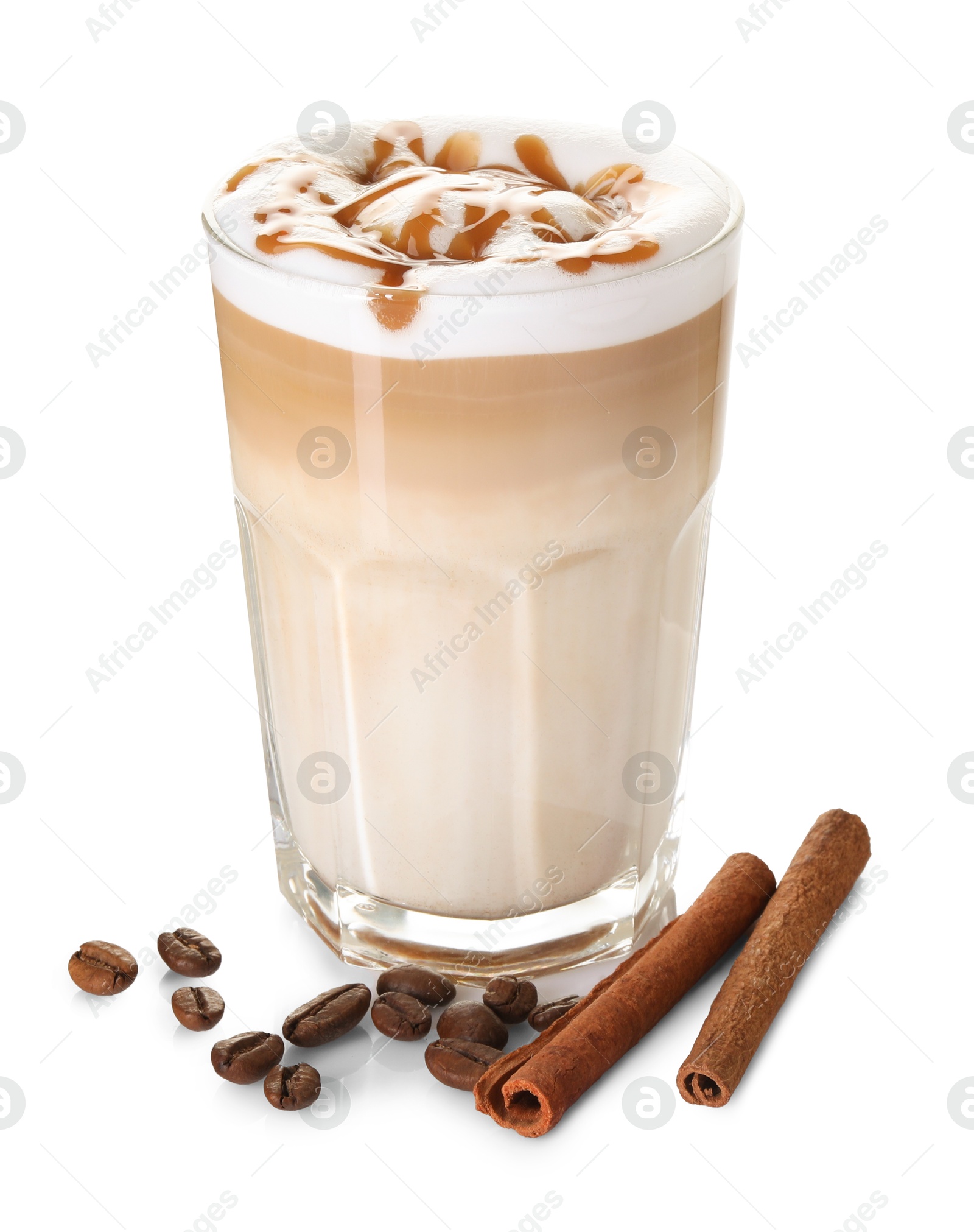 Photo of Tasty latte macchiato in glass, coffee beans and cinnamon isolated on white