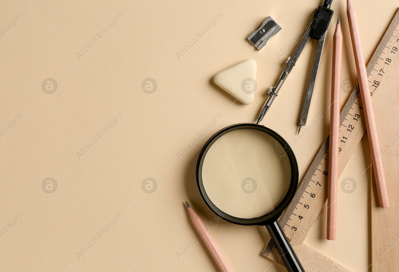 Photo of Flat lay composition with ruler and other stationery on beige background, space for text