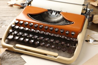 Photo of Vintage typewriter and paper sheets on table, closeup
