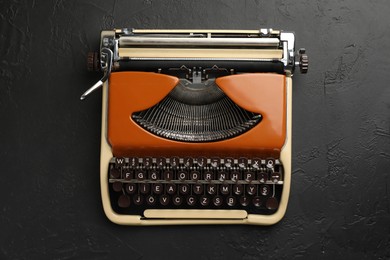 Photo of Vintage typewriter on black background, top view