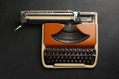 Photo of Vintage typewriter on black background, top view